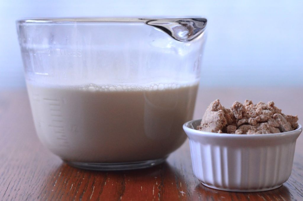 bowl of almond milk sitting next to bowl of almond pulp