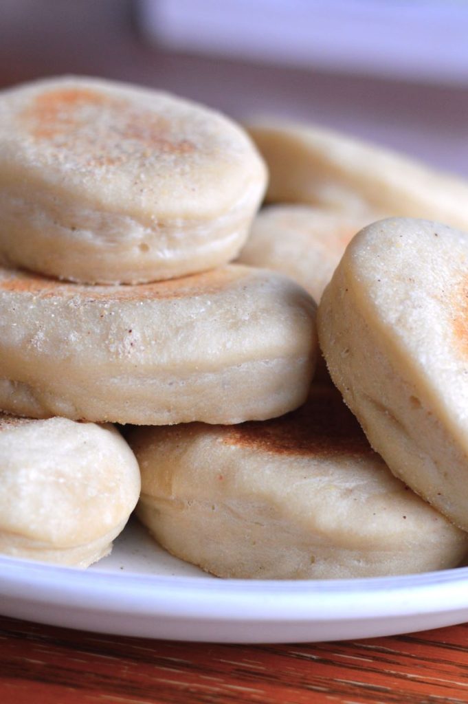 pile of sourdough english muffins on plate