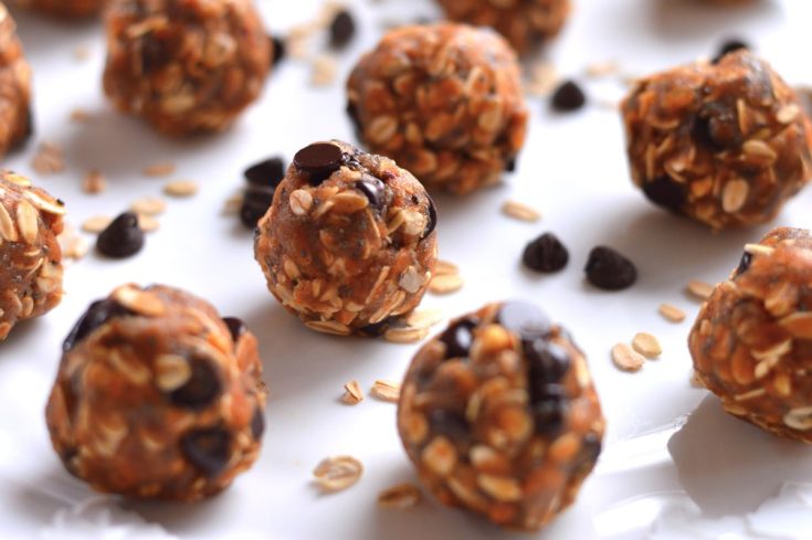close up of peanut butter balls with almond pulp on plate