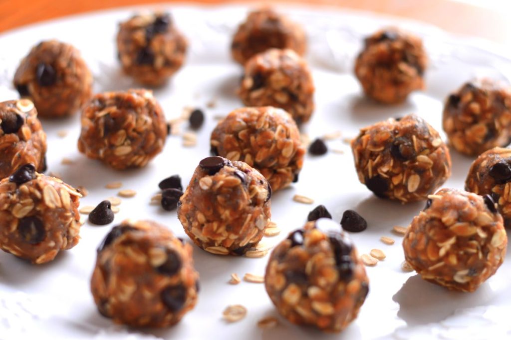 Many peanut butter balls with almond pulp on a tray