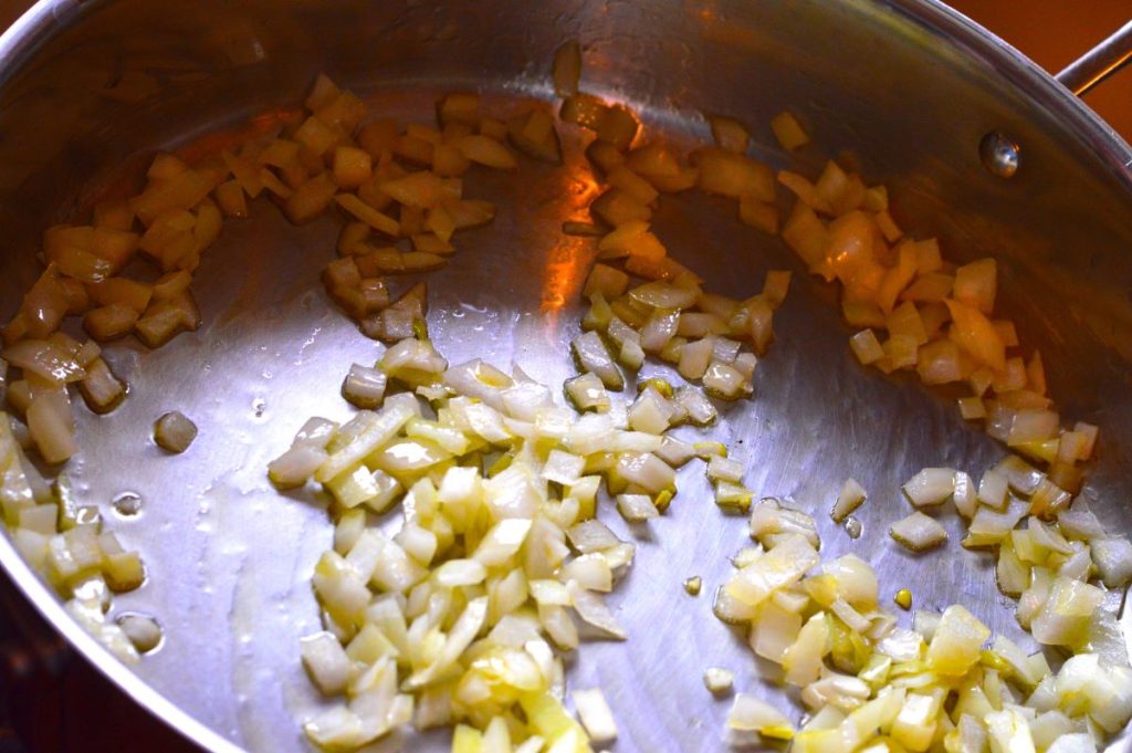 fry pan of chopped onions cooking in oil