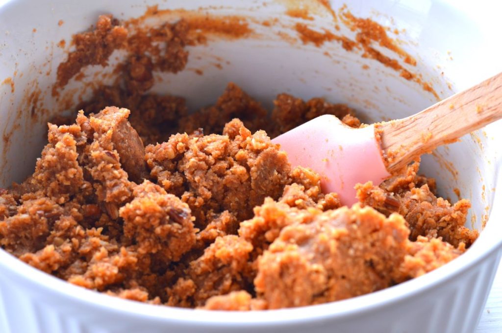 bowl of peanut butter and almond pulp mixture stirred into a crumbly, moist dough