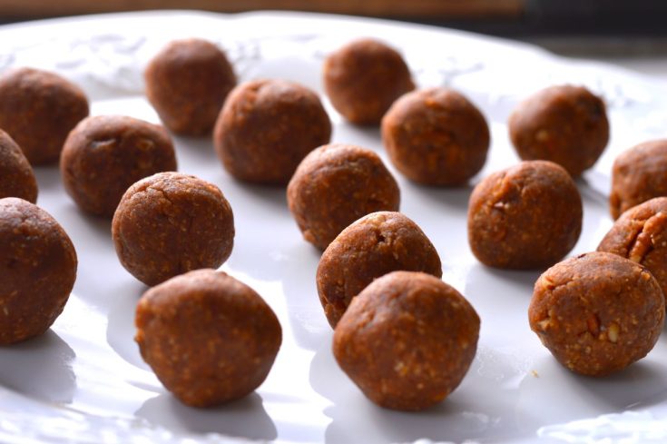 peanut butter balls spread out on white plate