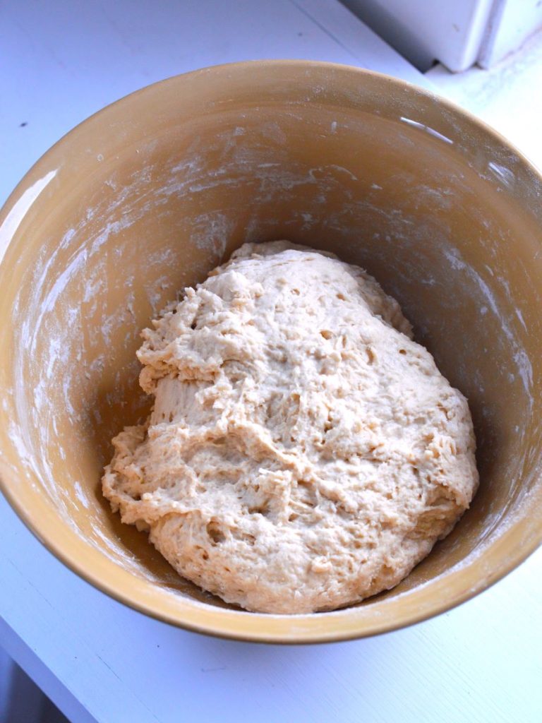 roughly mixed dough in a yellow bowl