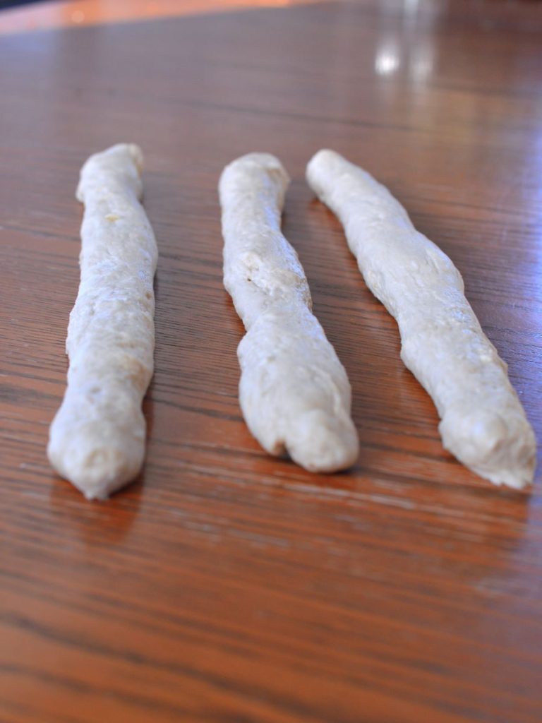 three sections of dough rolled into snake-like shape