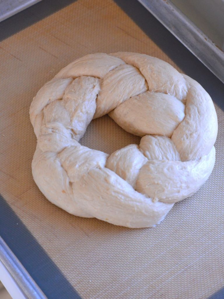 top view of uncooked braided bread dough on cookie sheet