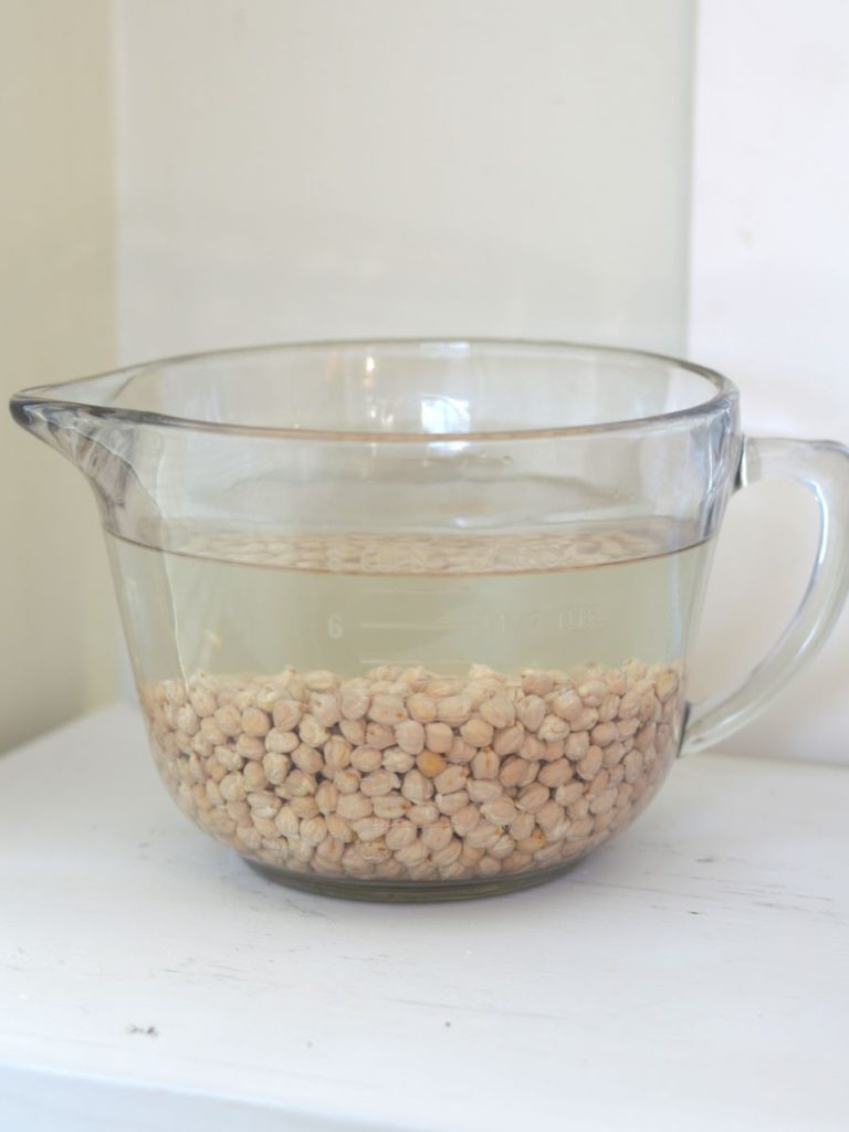 glass bowl of chickpeas covered with water