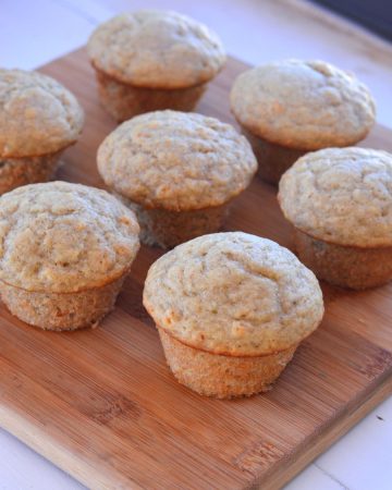 seven muffins on wood cutting board
